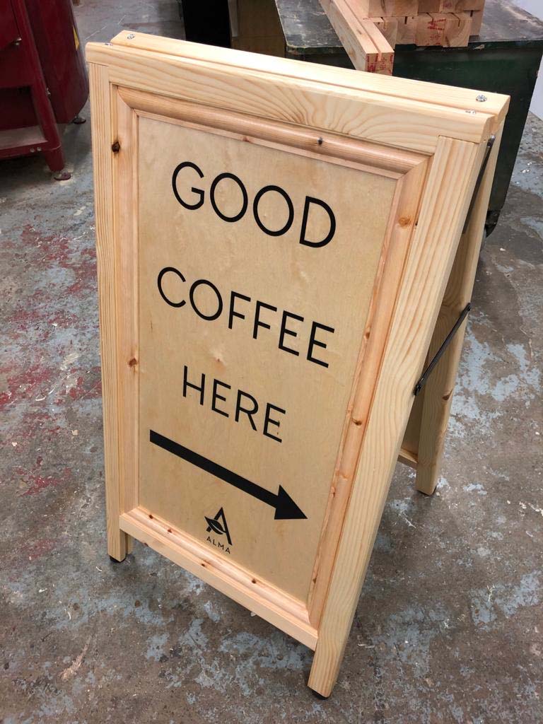 good coffee this way a board pavement sign
